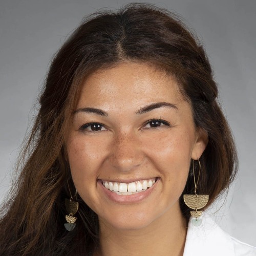 woman smiling wearing a lab coat