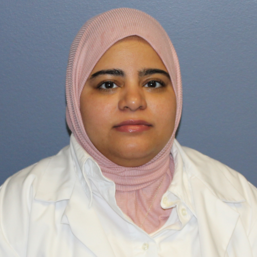 woman wearing a pink hijab and a lab coat