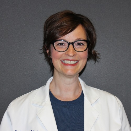 woman wearing glasses and a lab coat against a dark blue background
