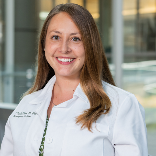 woman smiling wearing a lab coat