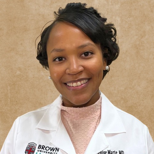 woman smiling wearing a lab coat and a pink shirt against a tan background