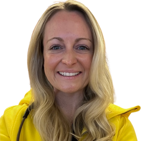 blonde woman smiling wearing a yellow coat with a stethoscope around her neck 