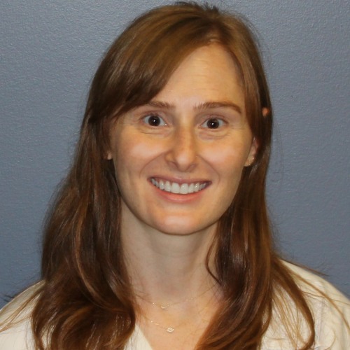 woman smiling wearing a lab coat