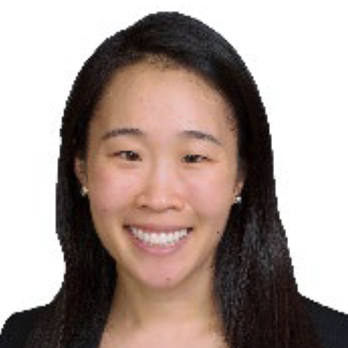 woman smiling wearing a black shirt and white blazer