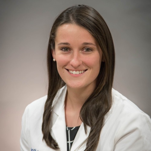 physician smiling wearing a lab coat