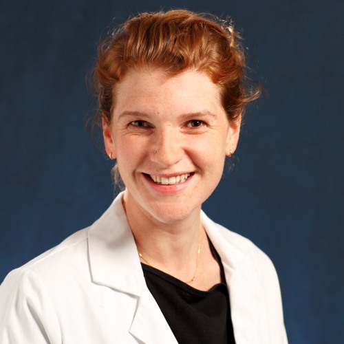 physician smiling wearing a lab coat