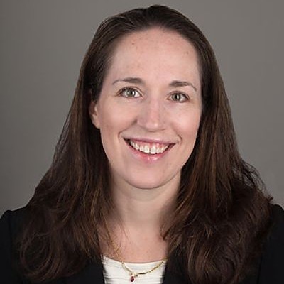 physician smiling wearing a black blazer