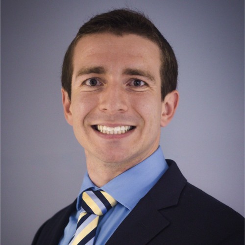 physician smiling wearing a black blazer