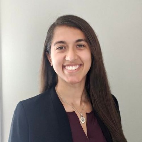 physician smiling wearing a black blazer