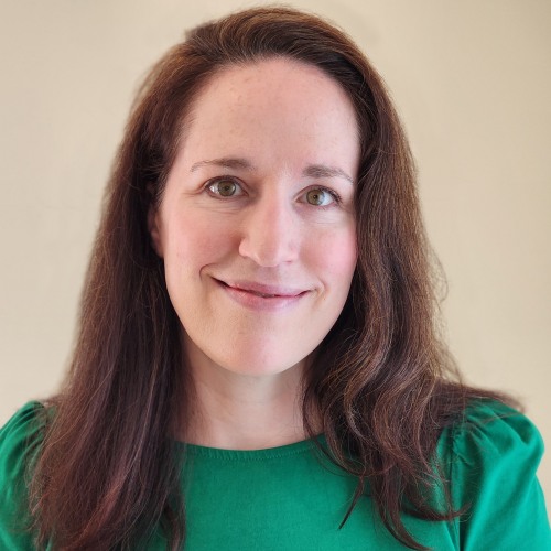 physician smiling wearing a green shirt