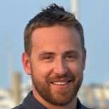 physician smiling wearing a black button up shirt