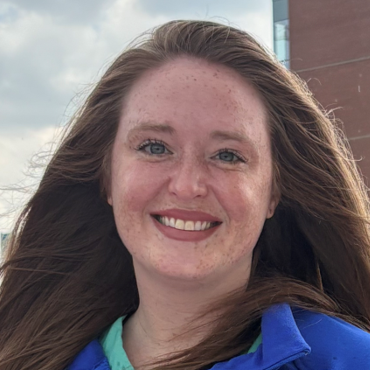 physician smiling wearing a blue shirt