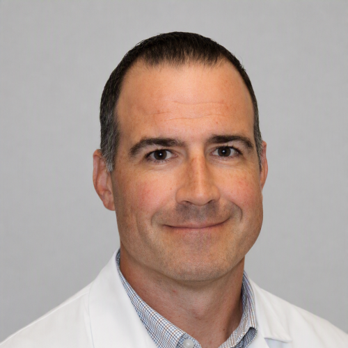 man smiling wearing a lab coat