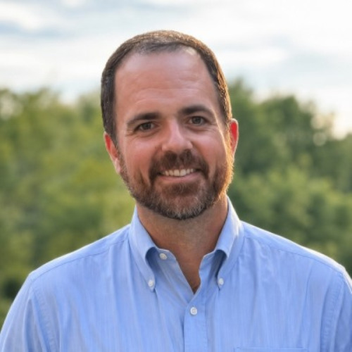 man with beard wearing a blue button down shirt