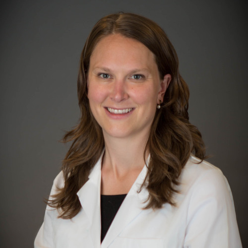 woman smiling wearing a lab coat