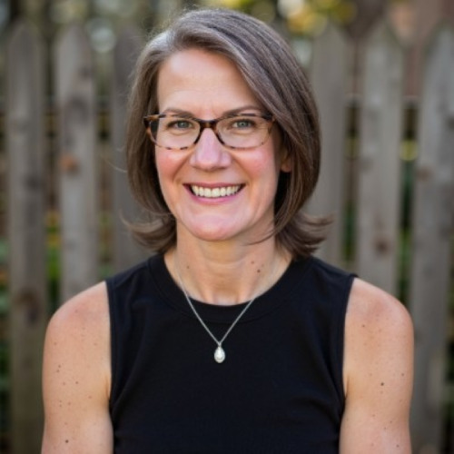 woman with glasses wearing a black sleeveless top