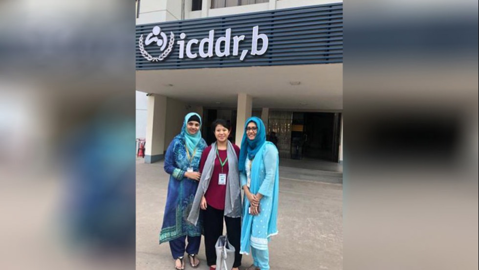 people posing outside a building