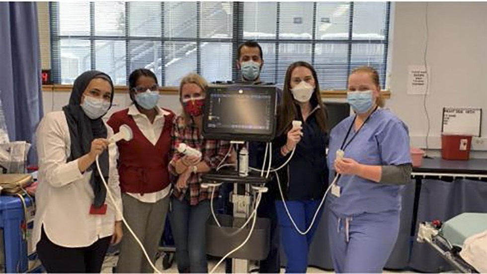 people posing with ultrasound equipment