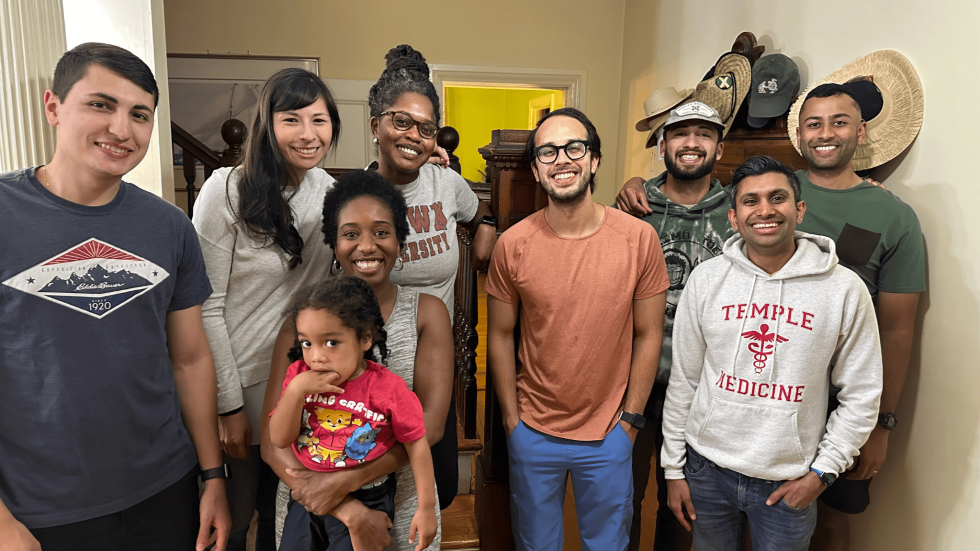 a group of smiling physicians and their families