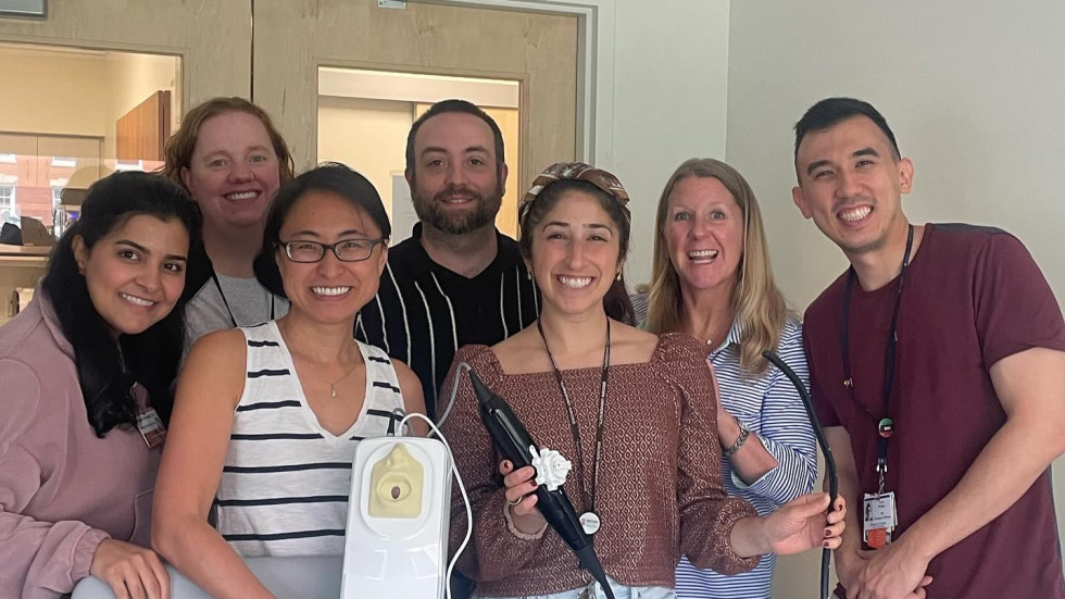 group of people holding an ultrasound device